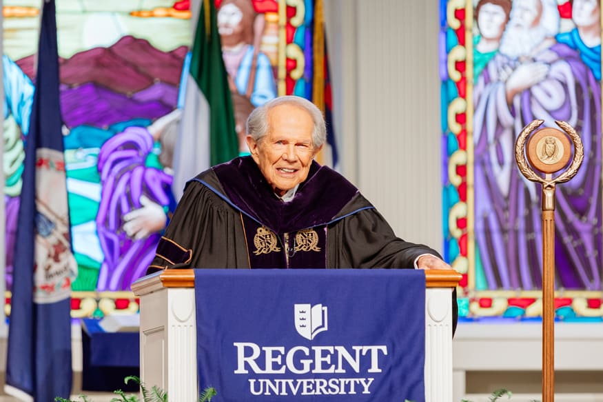 Professors celebrating as balloons fall at Regent University Commencement 2021